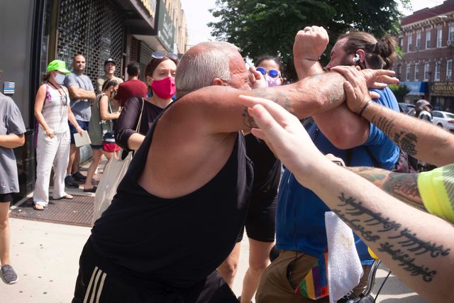 A man punches a Black Lives Matter counter-protester in Brooklyn July 11th, 2020.